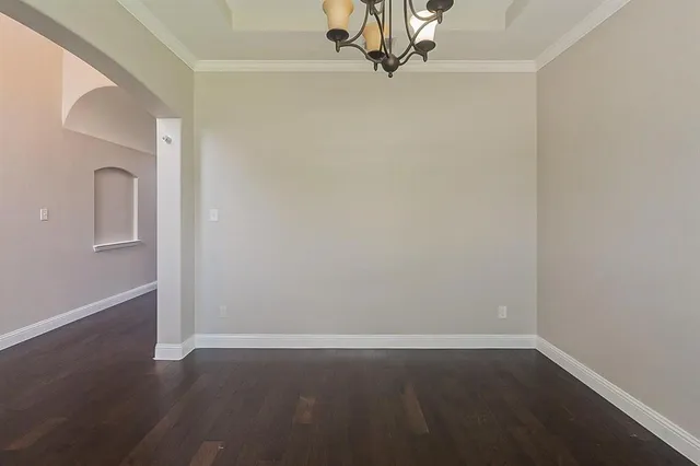 a view of a small space with wooden floor and a window