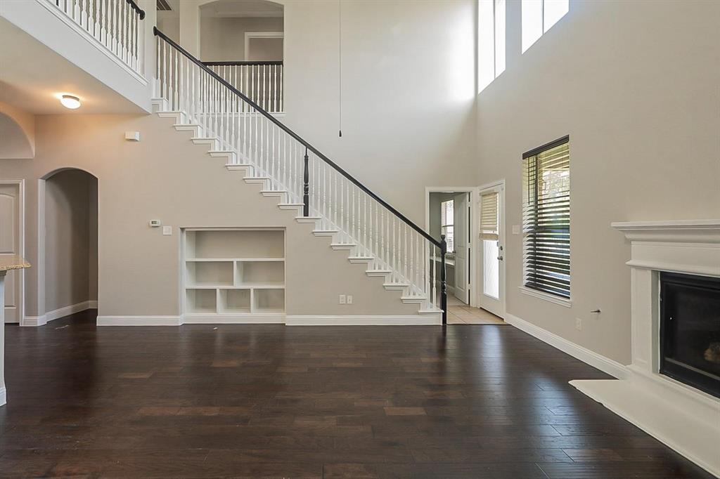 4433 Paula Ridge Court Fort Worth, TX 76137 - Photo 8 of 24 a view of empty room with wooden floor and fireplace