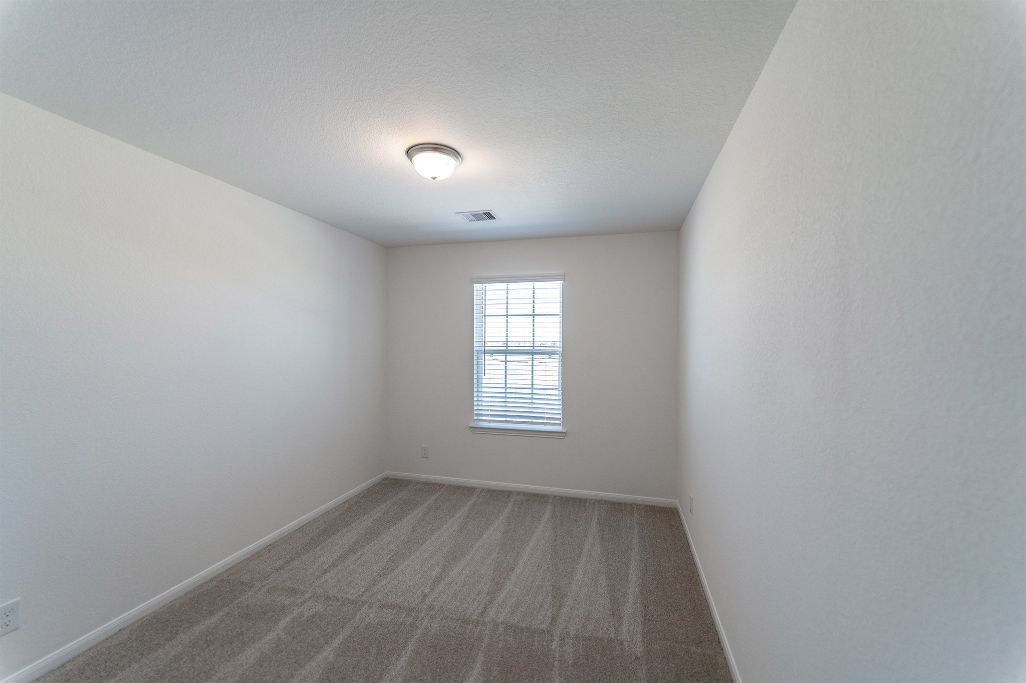 438 Hazy Meadows Drive Beasley, TX 77417 - Photo 11 of 21 wooden floor in an empty room with a window