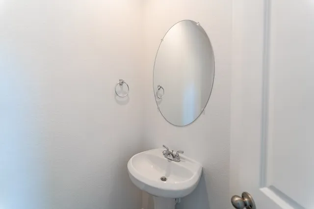 a bathroom with a sink and mirror