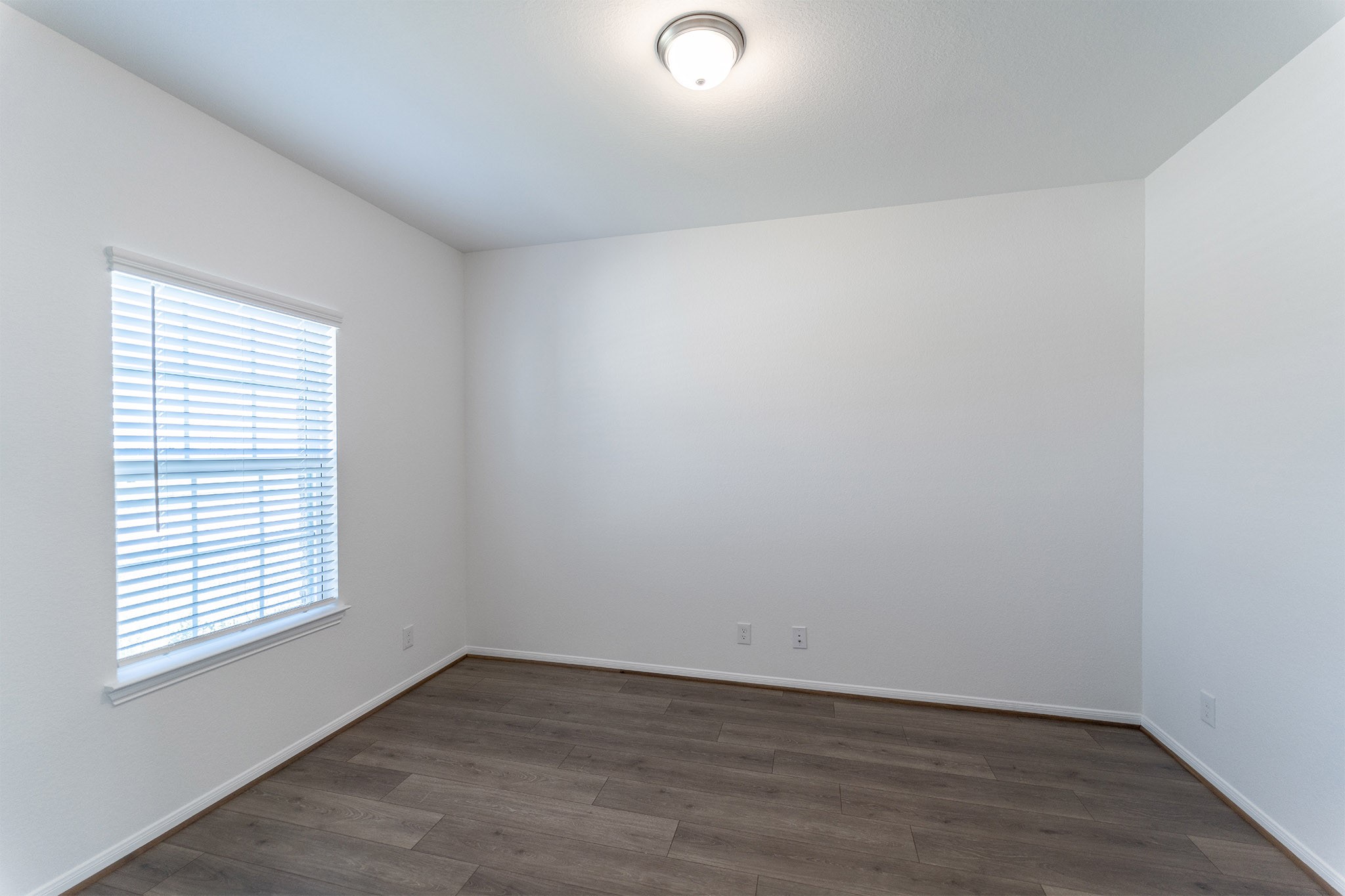438 Hazy Meadows Drive Beasley, TX 77417 - Photo 20 of 21 an empty room with wooden floor and windows