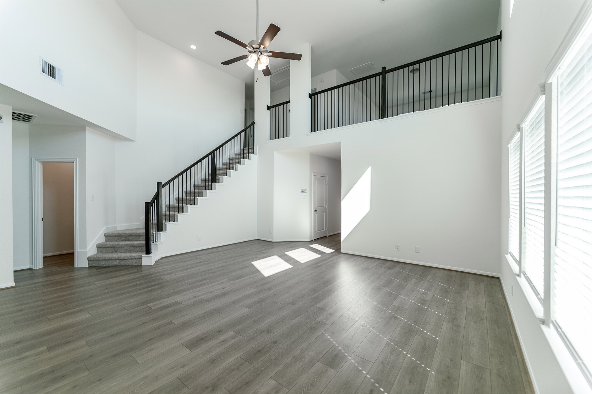 438 Hazy Meadows Drive Beasley, TX 77417 - Photo 5 of 21 a view of an empty room with wooden floor and a window