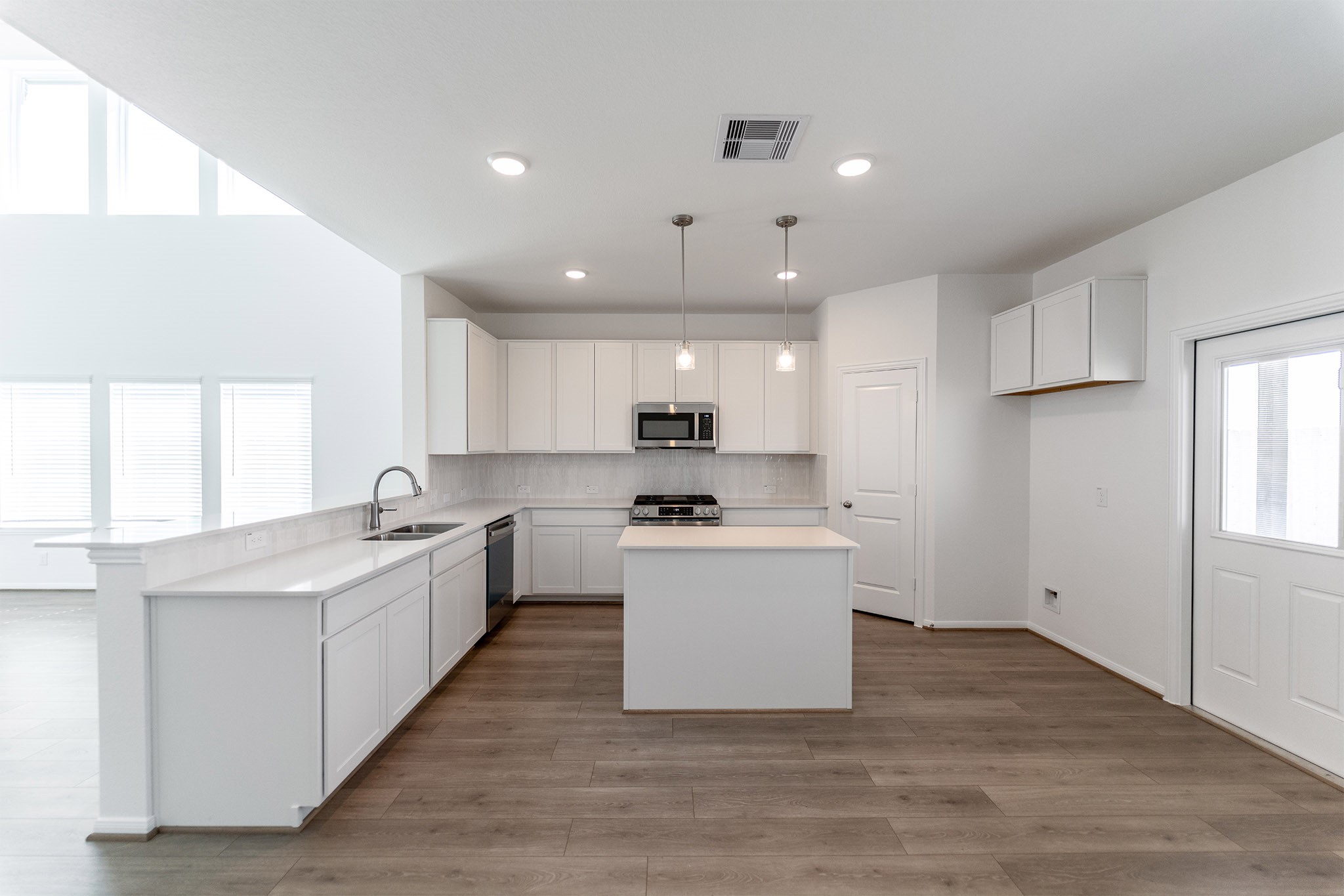 438 Hazy Meadows Drive Beasley, TX 77417 - Photo 8 of 21 a kitchen with a sink stove and refrigerator