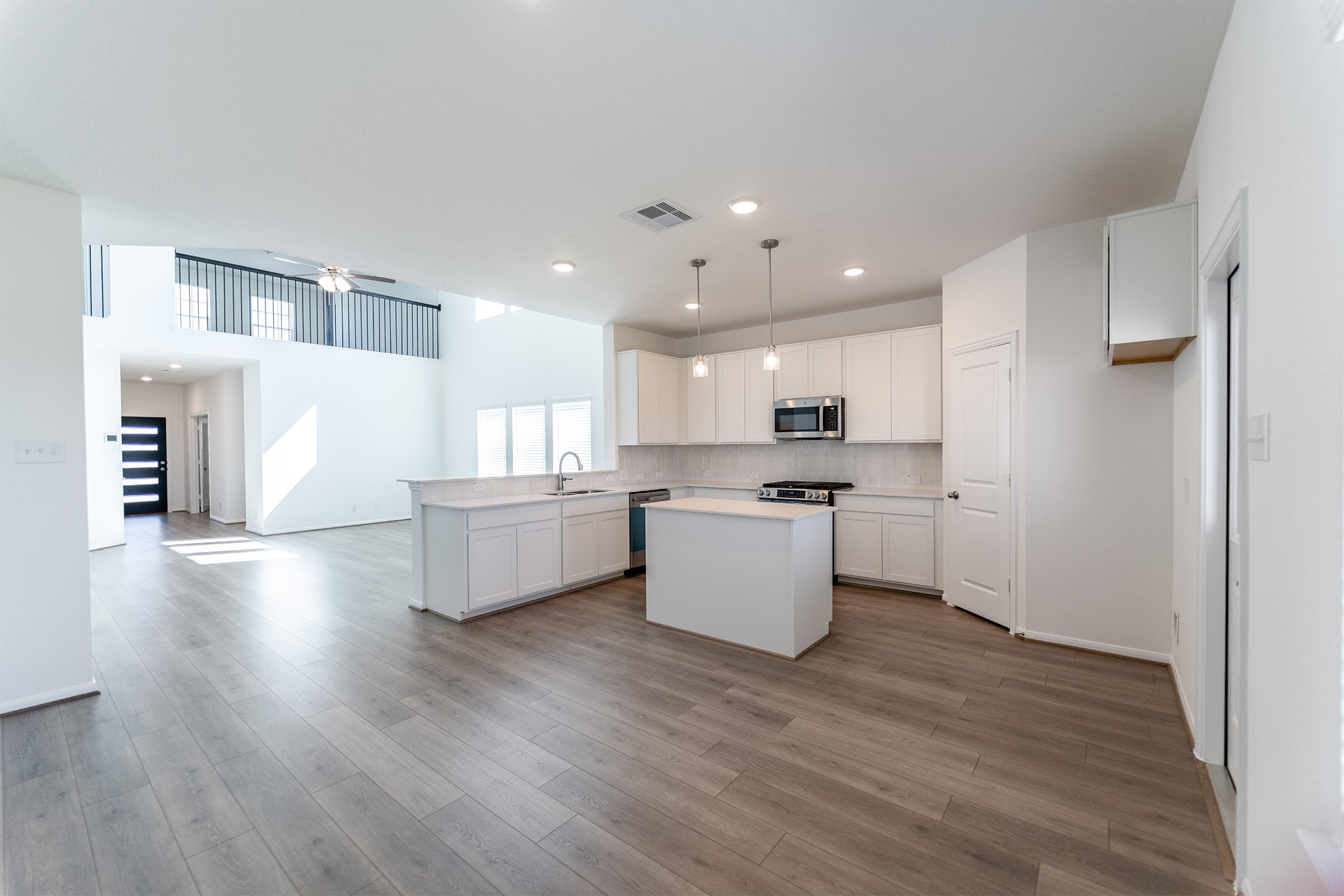438 Hazy Meadows Drive Beasley, TX 77417 - Photo 9 of 21 a large white kitchen with a white stove top oven and white refrigerator