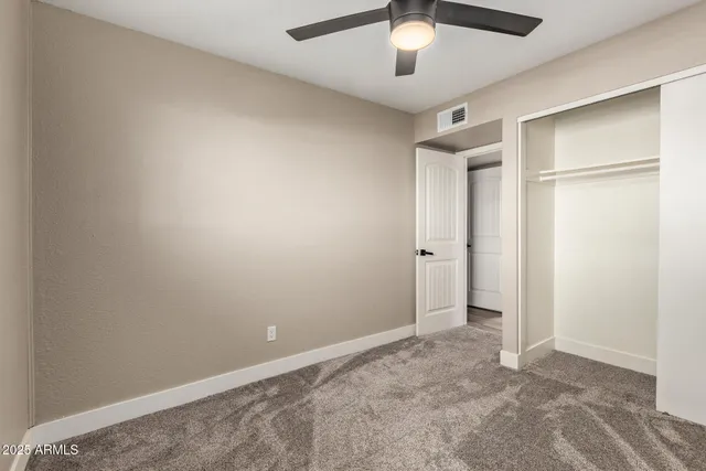 an empty room with a empty space and a ceiling fan