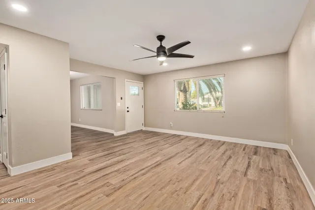 wooden floor in an empty room with a window