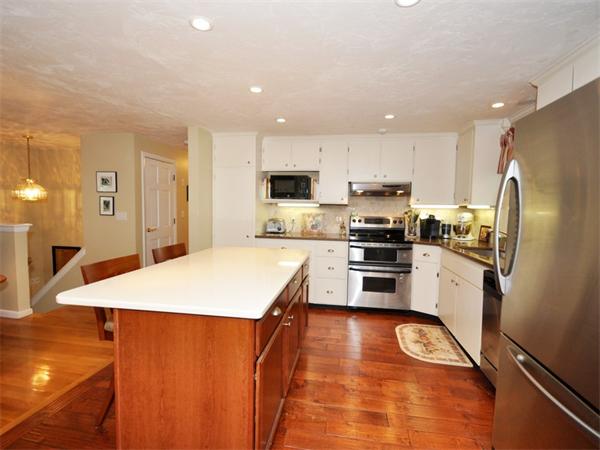 79 Harvard Road Stow, MA 01775 - Photo 4 of 21 a kitchen with stainless steel appliances a refrigerator and a stove top oven