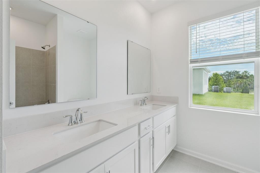 1672 Rider Rain Lane Apopka, FL 32703 - Photo 25 of 35 a bathroom with a granite countertop sink and a window