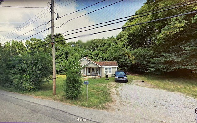 a view of a house with a backyard and a patio