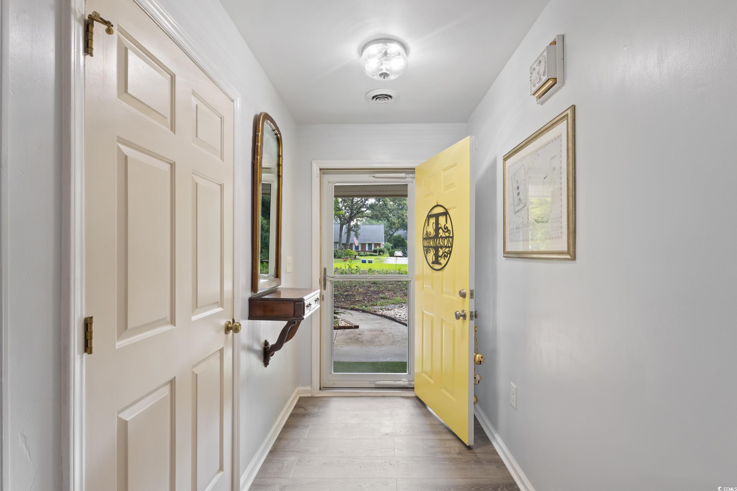 815 Tillson Road North Myrtle Beach, SC 29582 - Photo 13 of 39 Entrance foyer with wood finished floors and baseboards