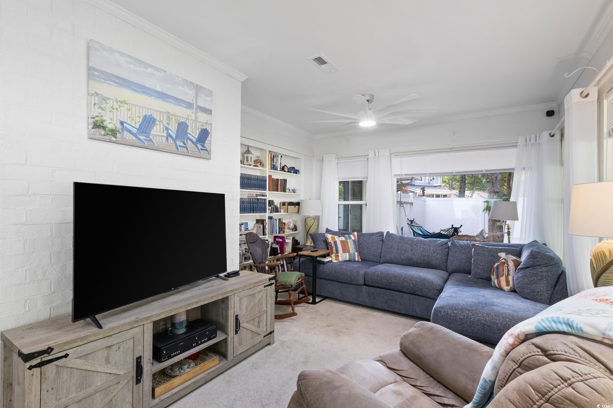 815 Tillson Road North Myrtle Beach, SC 29582 - Photo 14 of 39 Carpeted living area featuring crown molding and a ceiling fan