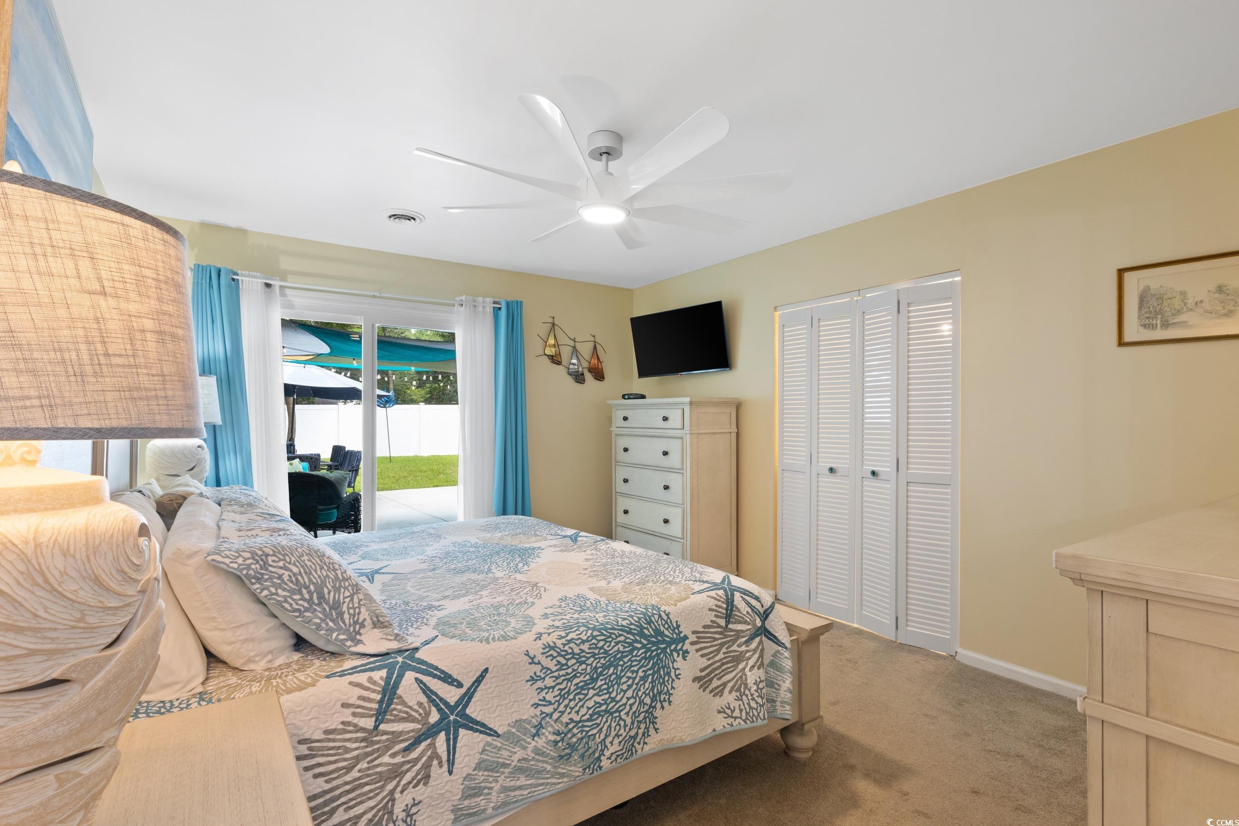 815 Tillson Road North Myrtle Beach, SC 29582 - Photo 16 of 39 Carpeted bedroom featuring access to outside, a closet, and ceiling fan