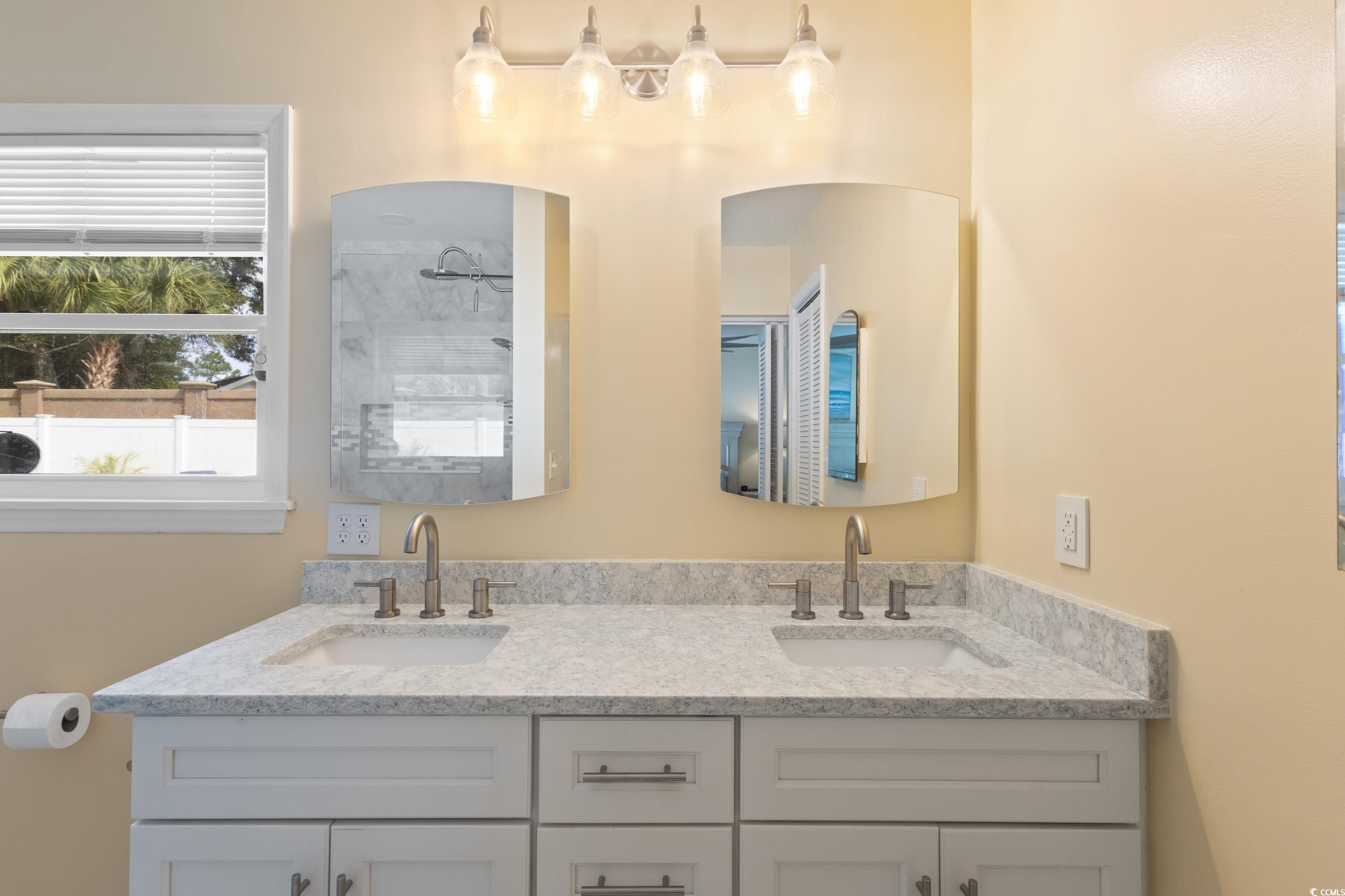 815 Tillson Road North Myrtle Beach, SC 29582 - Photo 19 of 39 Bathroom with double vanity and a tile shower