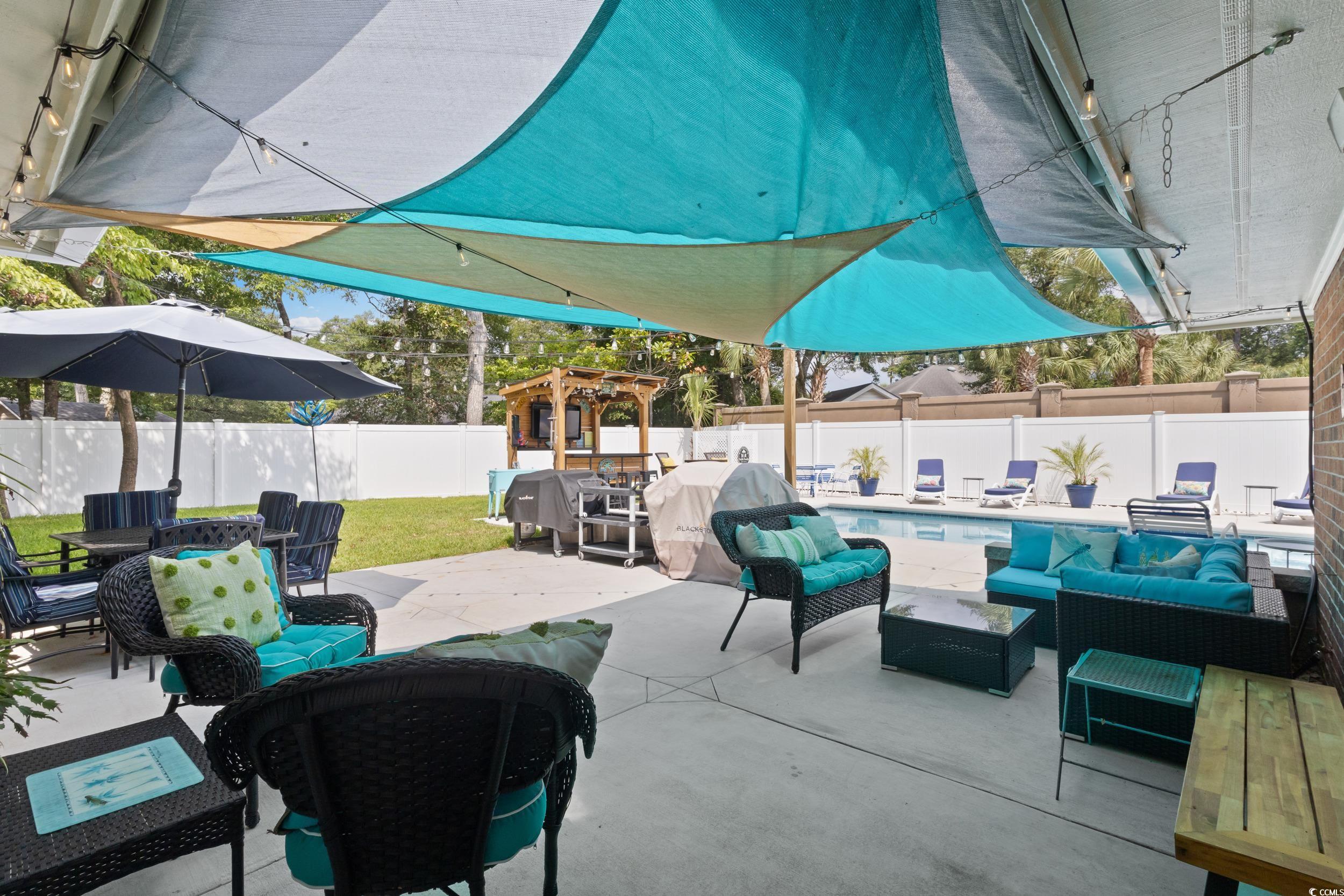 815 Tillson Road North Myrtle Beach, SC 29582 - Photo 2 of 39 Fenced backyard with an outdoor living space, a pergola, a patio area, and outdoor dining space