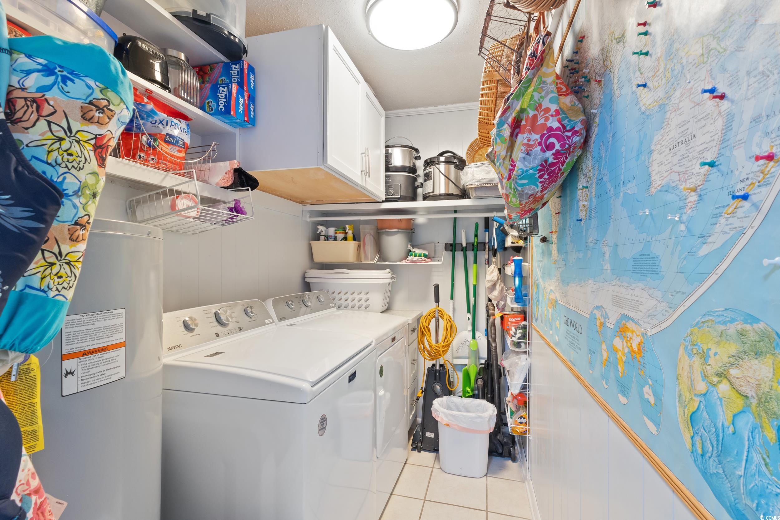 815 Tillson Road North Myrtle Beach, SC 29582 - Photo 22 of 39 Washroom with independent washer and dryer, cabinet space, water heater, light tile patterned flooring, and crown molding