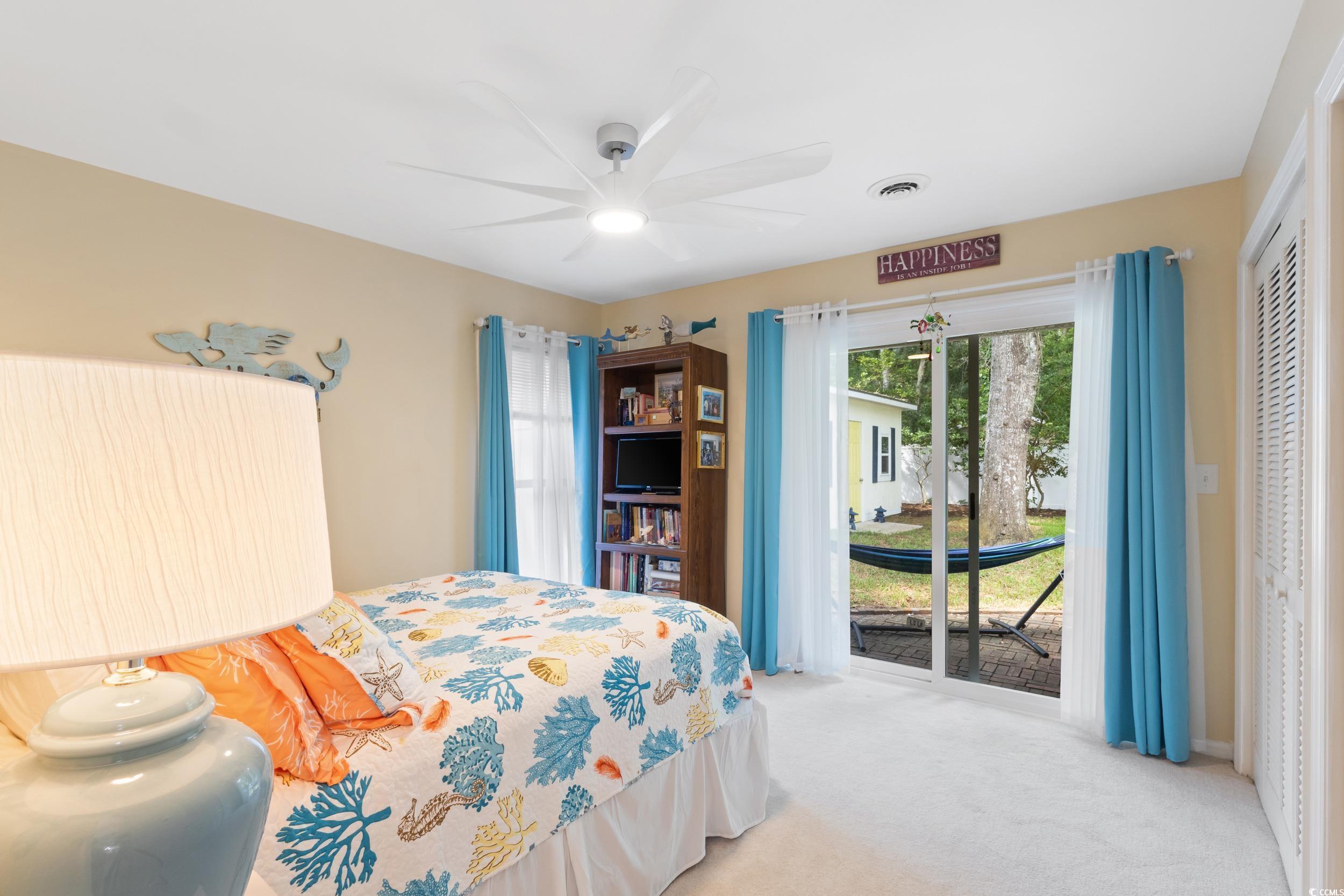 815 Tillson Road North Myrtle Beach, SC 29582 - Photo 26 of 39 Bedroom with carpet, access to exterior, a closet, and a ceiling fan