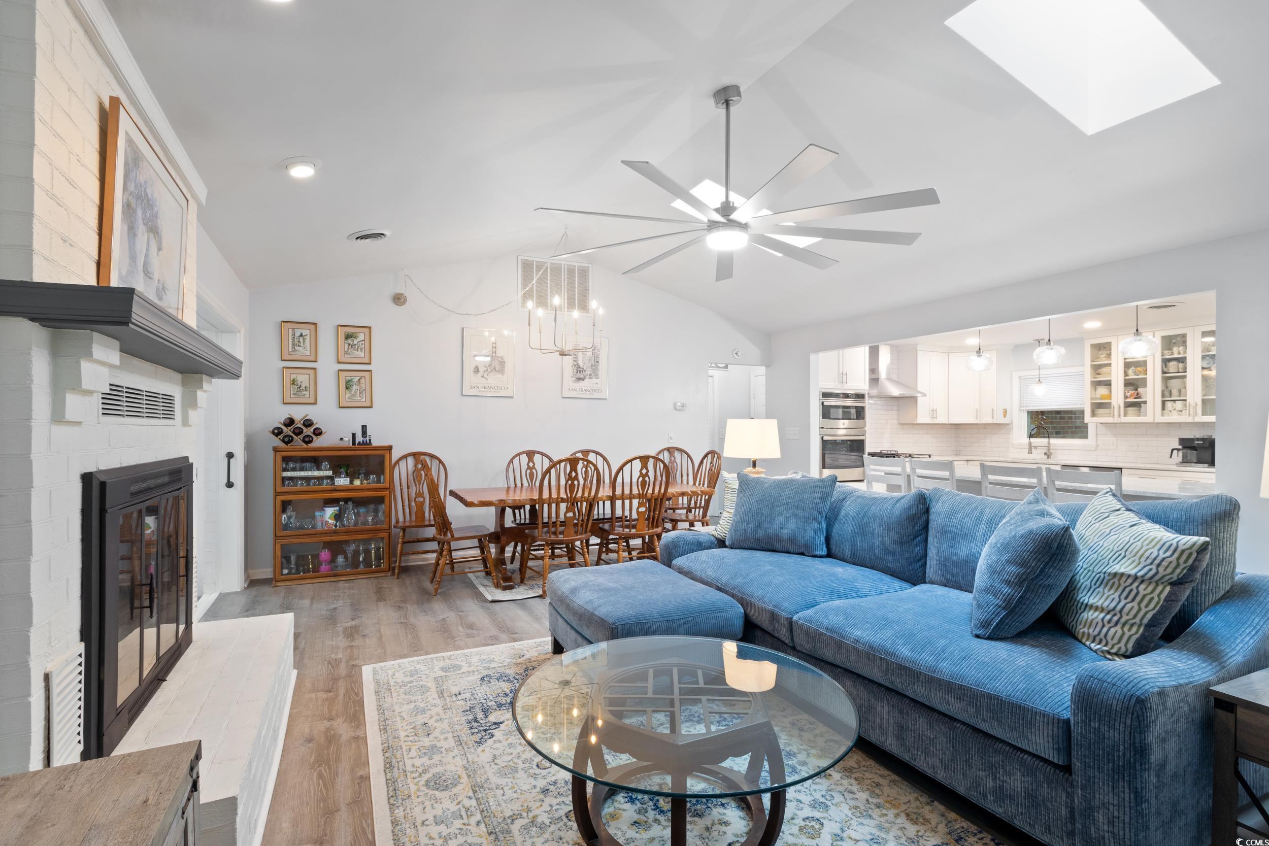 815 Tillson Road North Myrtle Beach, SC 29582 - Photo 8 of 39 Living area featuring a brick fireplace, lofted ceiling, ceiling fan, light wood-style floors, and recessed lighting