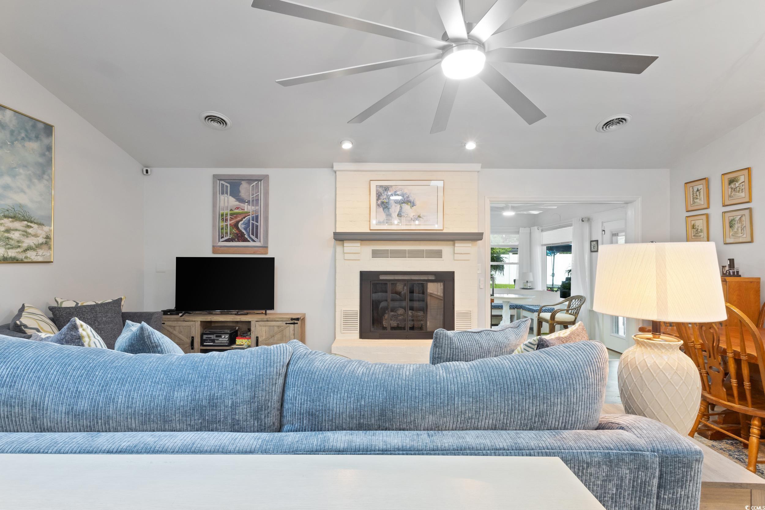 815 Tillson Road North Myrtle Beach, SC 29582 - Photo 9 of 39 Living room with a fireplace and a ceiling fan