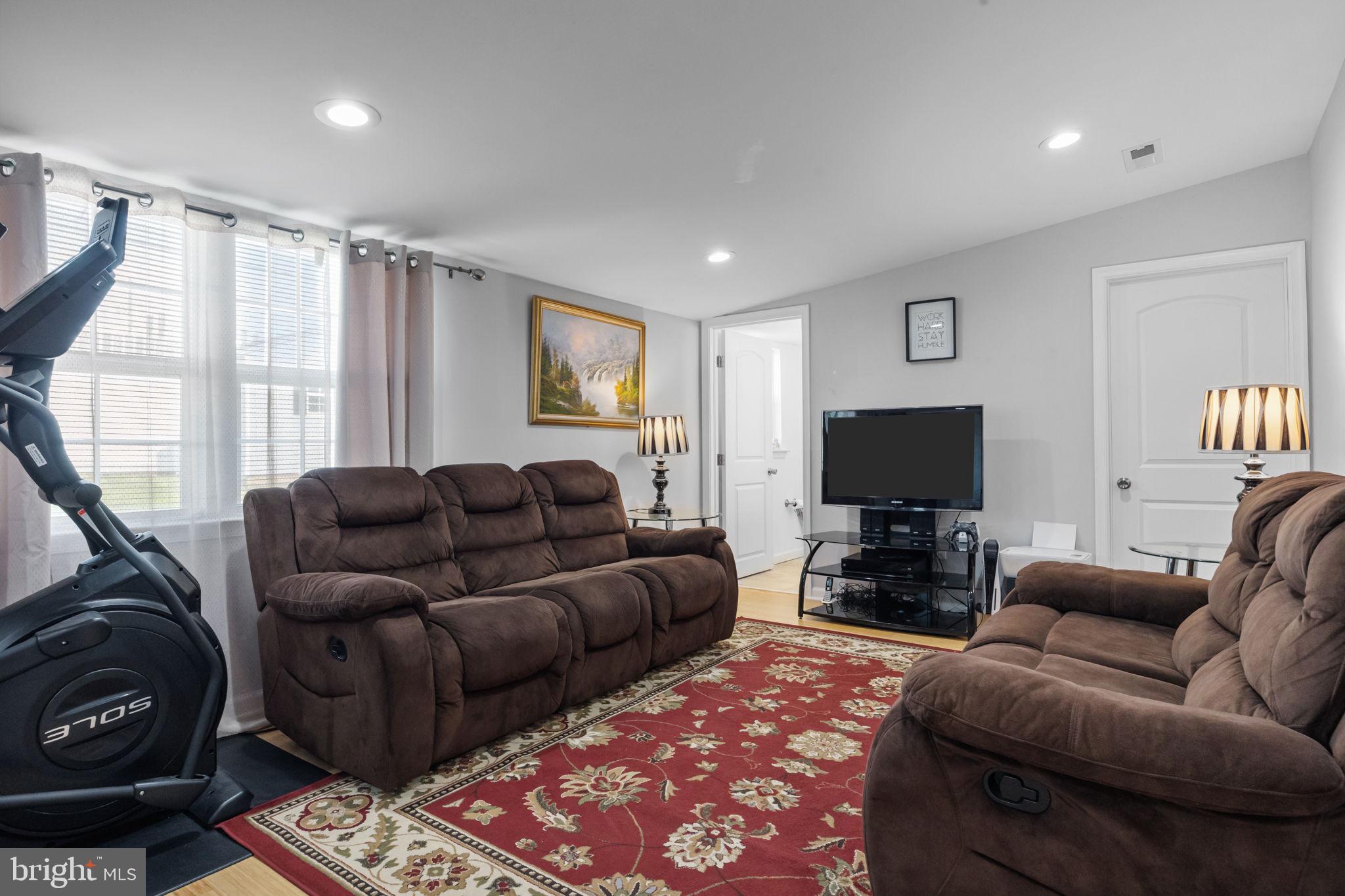 9 Verdant Road Levittown, PA 19057 - Photo 16 of 31 a living room with furniture a flat screen tv and a window