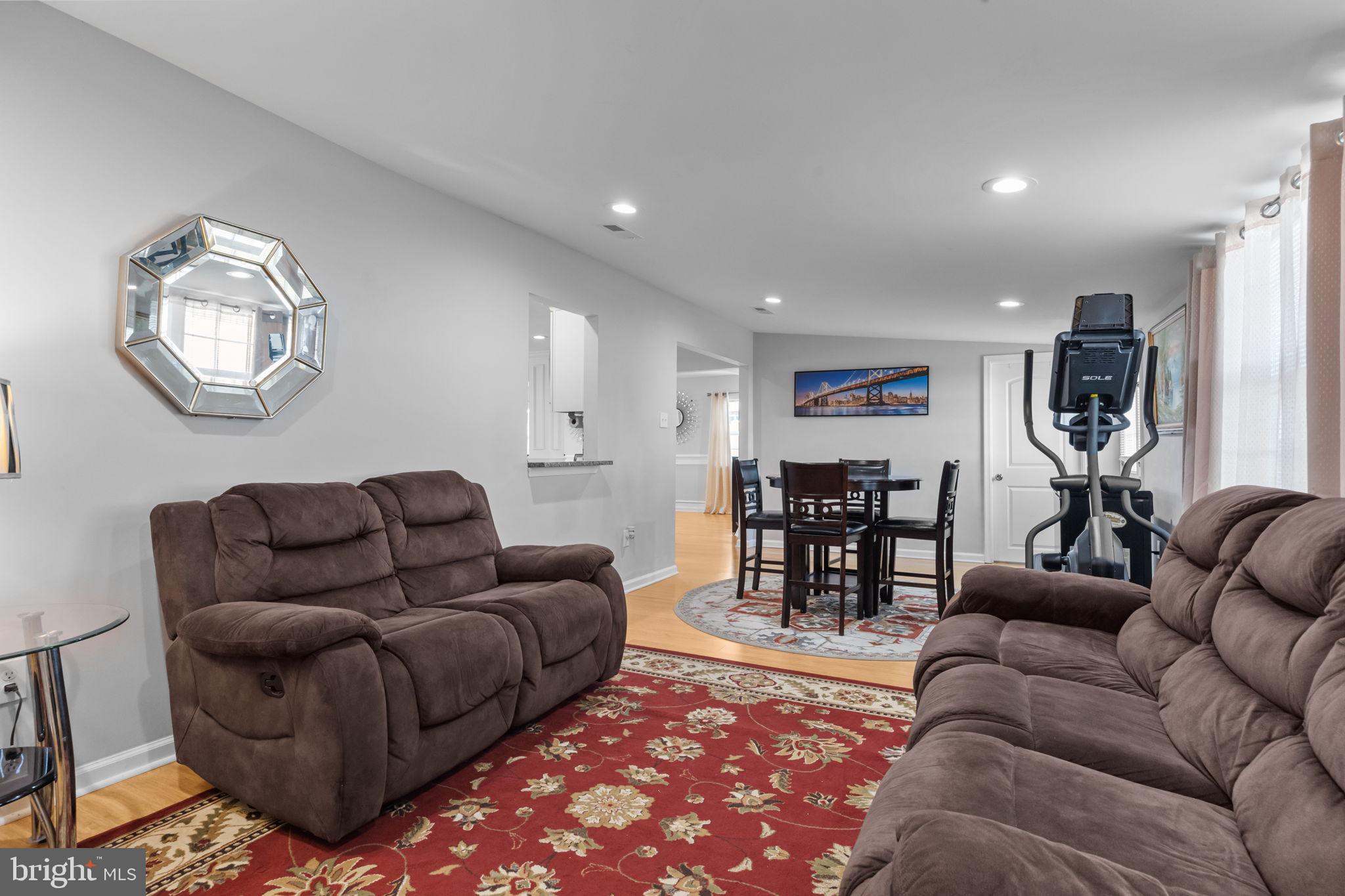 9 Verdant Road Levittown, PA 19057 - Photo 18 of 31 a living room with furniture a dining table and kitchen view