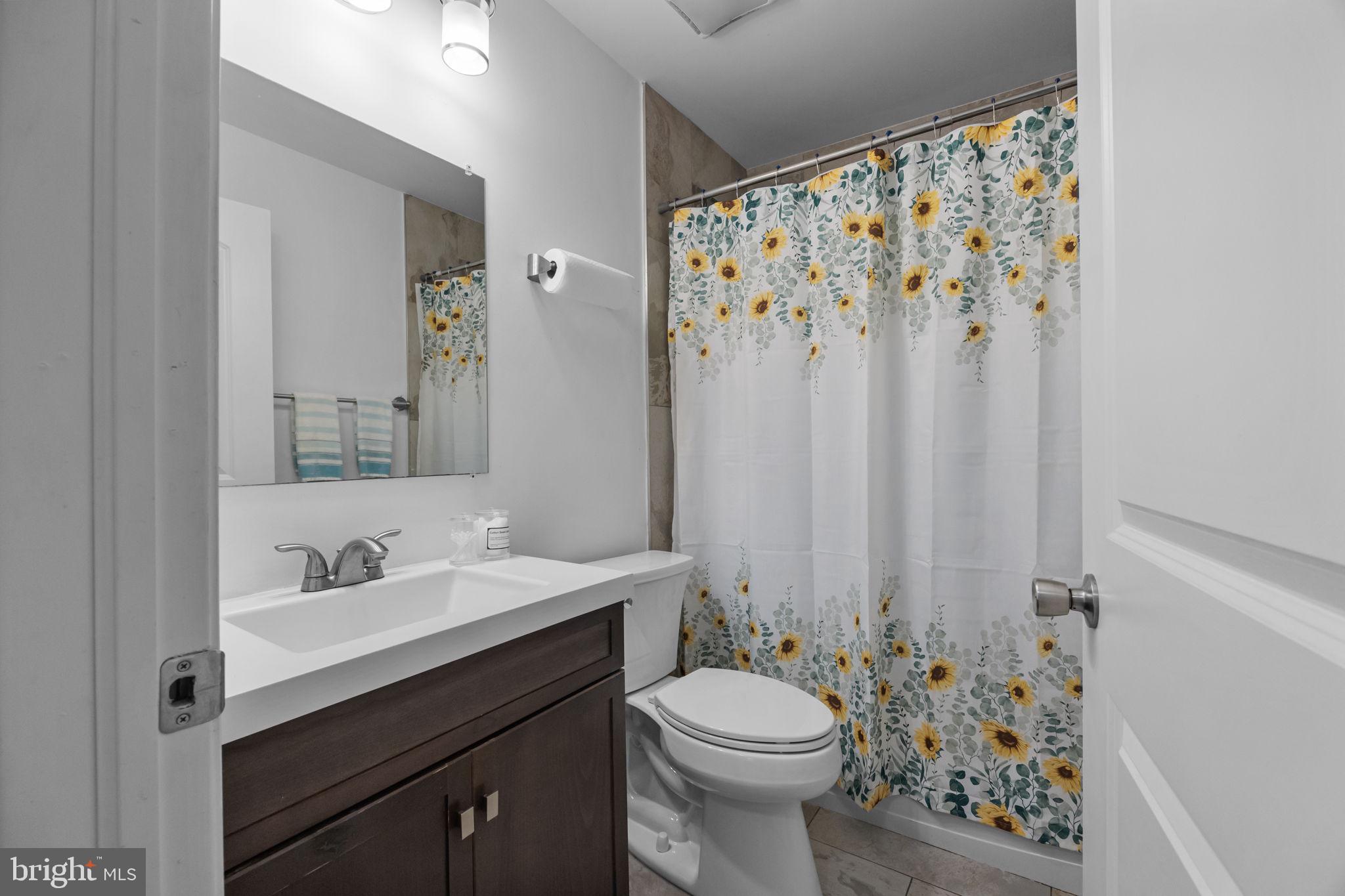 9 Verdant Road Levittown, PA 19057 - Photo 19 of 31 a bathroom with a sink a toilet and shower curtain