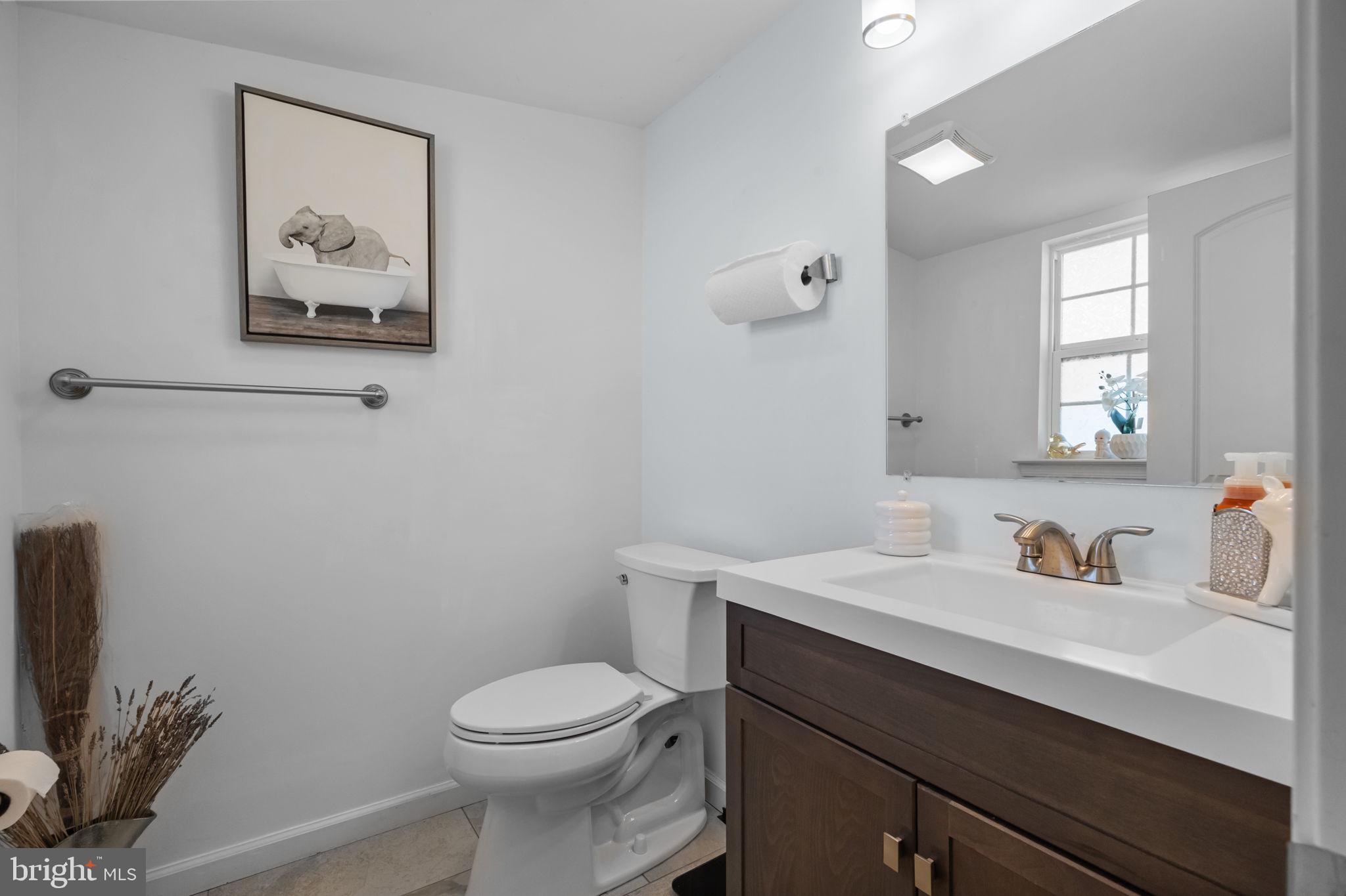 9 Verdant Road Levittown, PA 19057 - Photo 20 of 31 a bathroom with a toilet sink and mirror