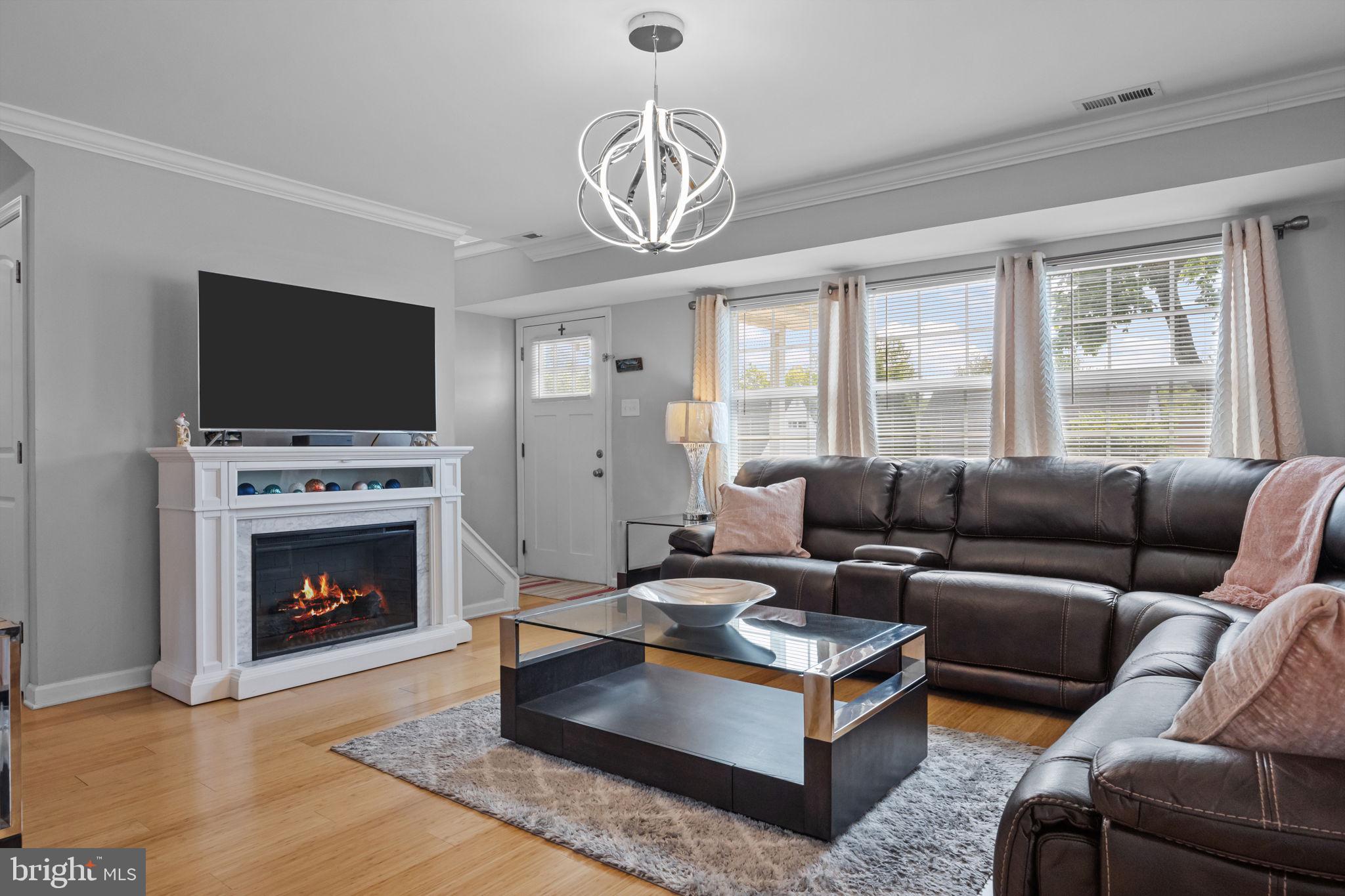 9 Verdant Road Levittown, PA 19057 - Photo 2 of 31 a living room with furniture a flat screen tv and a fireplace