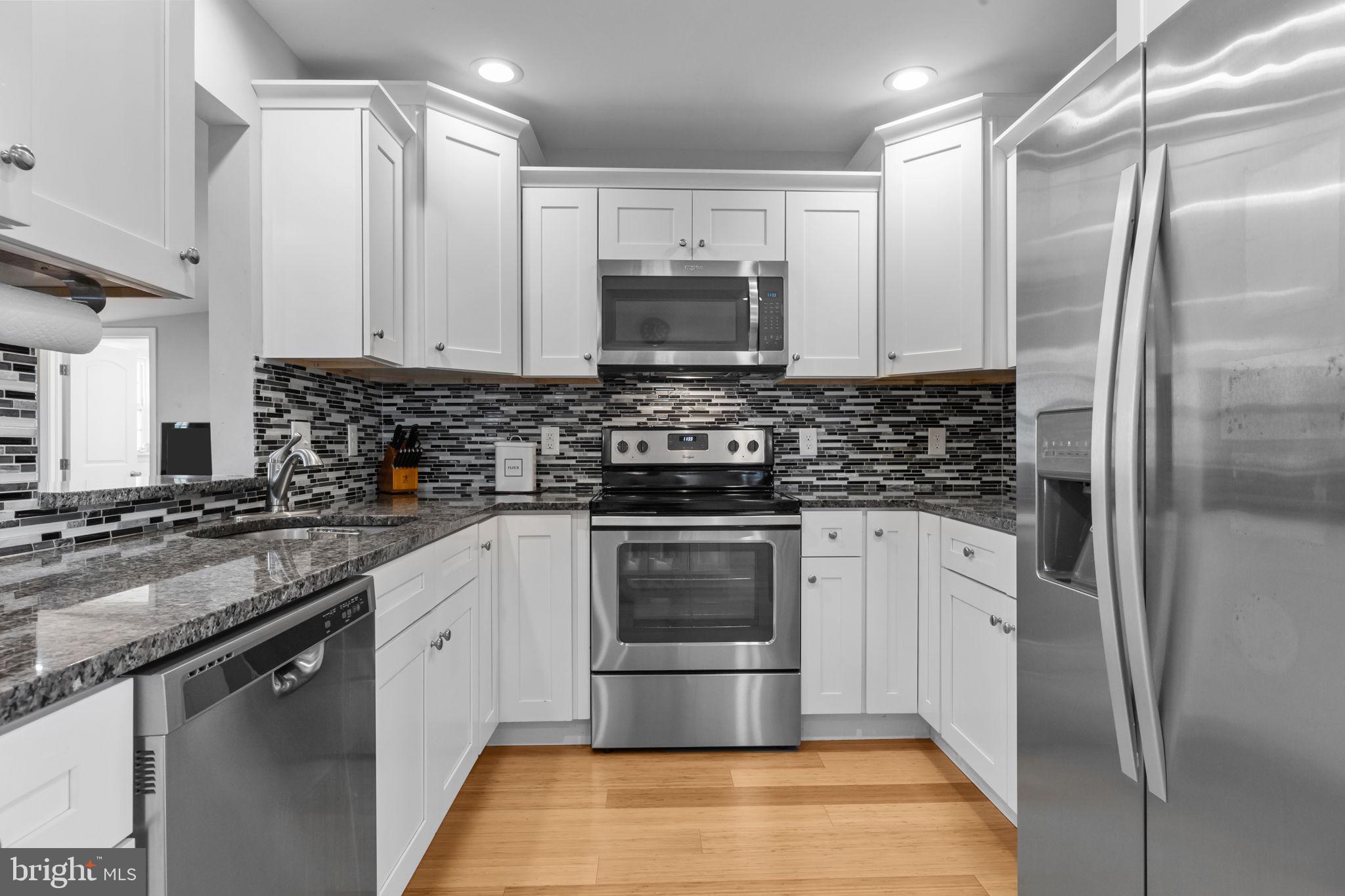 9 Verdant Road Levittown, PA 19057 - Photo 5 of 31 a kitchen with stainless steel appliances a stove a sink and a refrigerator