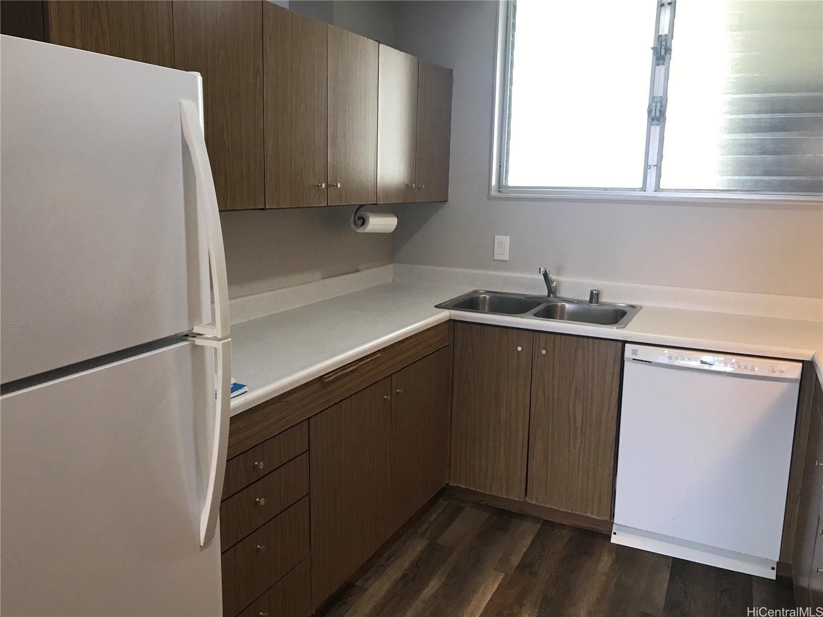 1717 Ala Wai Boulevard, Unit 2502 Honolulu, HI 96815 - Photo 11 of 15 a kitchen with a sink a refrigerator and window