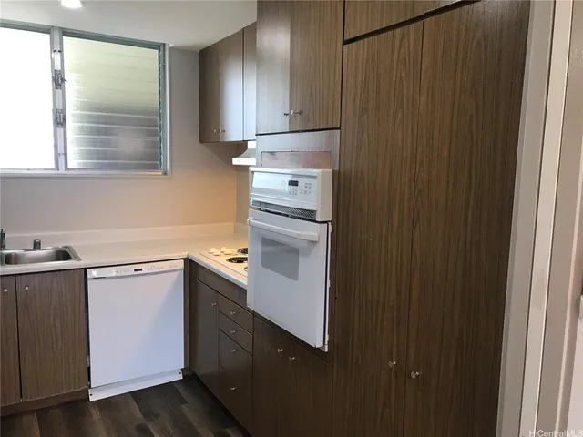 a kitchen with a sink cabinets and window