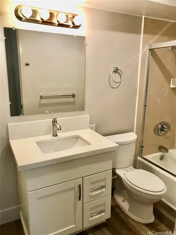 a bathroom with a sink a toilet and mirror