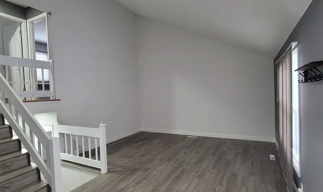 a view of an entryway with wooden floor