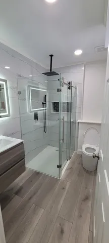 a spacious bathroom with a tub and shower
