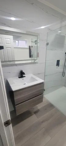 a bathroom with a bathtub and shower