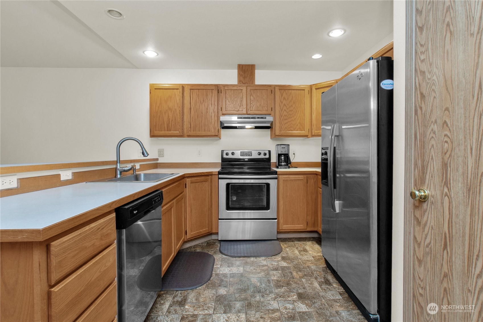 17406 Privet Court Southwest Rochester, WA 98579 - Photo 23 of 34 a kitchen with a sink stainless steel appliances and cabinets