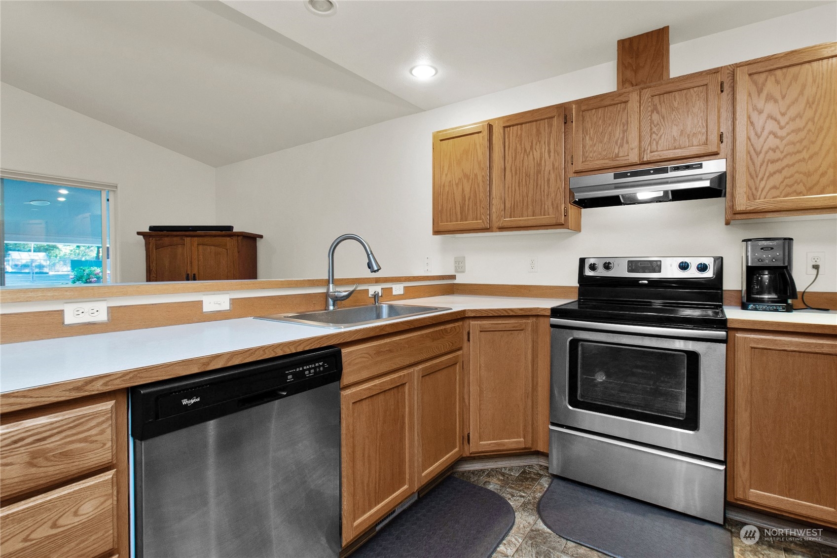 17406 Privet Court Southwest Rochester, WA 98579 - Photo 24 of 34 a kitchen with stainless steel appliances granite countertop a sink stove and microwave