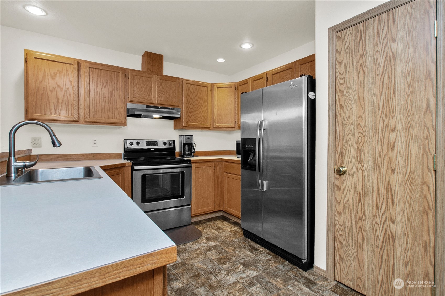 17406 Privet Court Southwest Rochester, WA 98579 - Photo 25 of 34 a kitchen with stainless steel appliances a refrigerator sink and cabinets