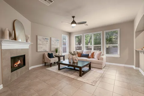 a living room with furniture and a fireplace