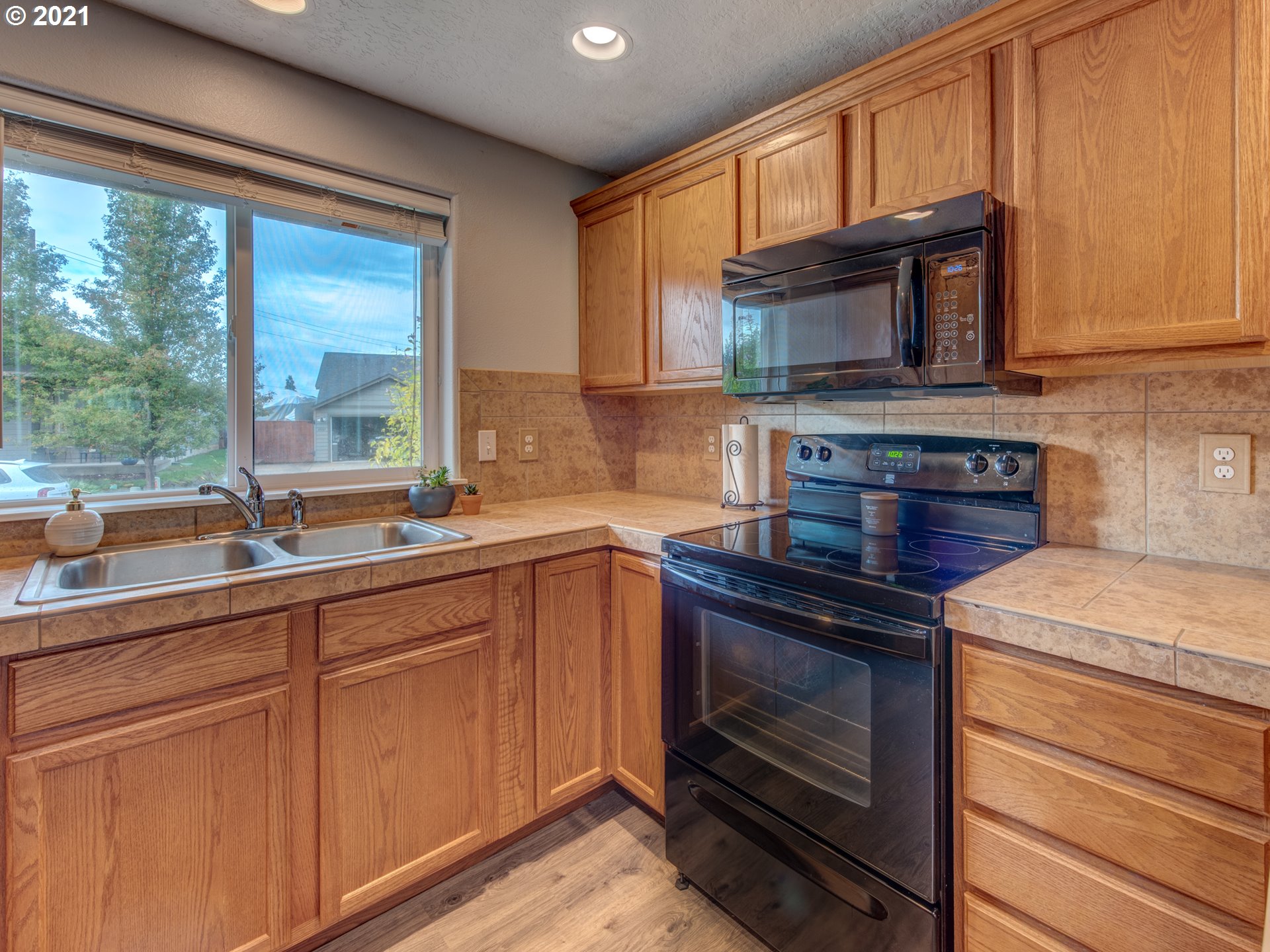 4808 Holly Street Springfield, OR 97478 - Photo 8 of 27 a kitchen with granite countertop a stove sink and microwave