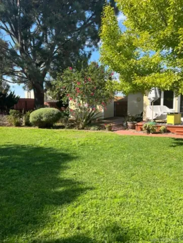 a view of a backyard with sitting area