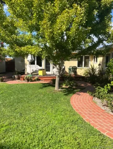 a view of a house with backyard porch and sitting area