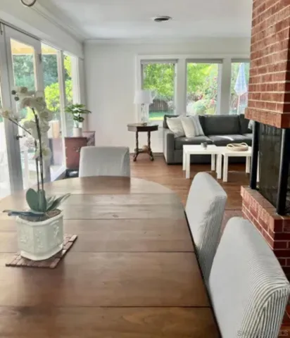 a living room with furniture and floor to ceiling windows