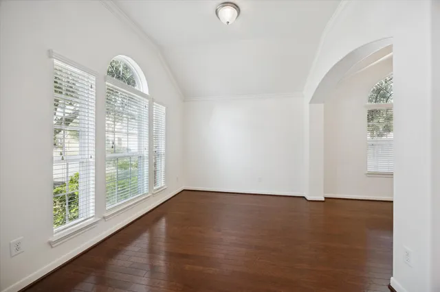 a view of room with window and wooden floor