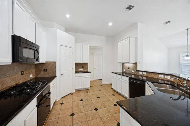 a kitchen with stainless steel appliances a sink stove and cabinets