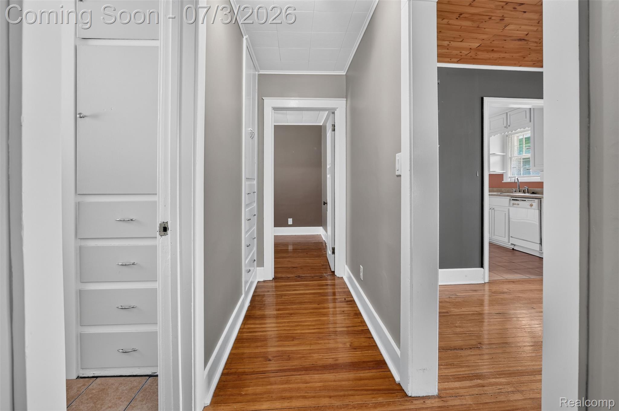 4322 Baker Road Bridgeport, MI 48722 - Photo 13 of 29 Hallway with wood-finish flooring and neutral wall tones