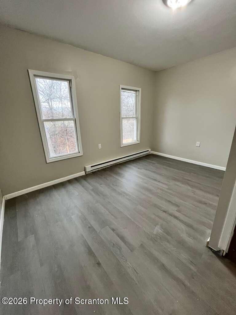 15 Amity Court Scranton, PA 18509 - Photo 4 of 9 an empty room with wooden floor and windows