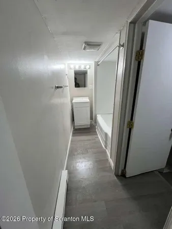 a view of a kitchen with a sink cabinets and wooden floor