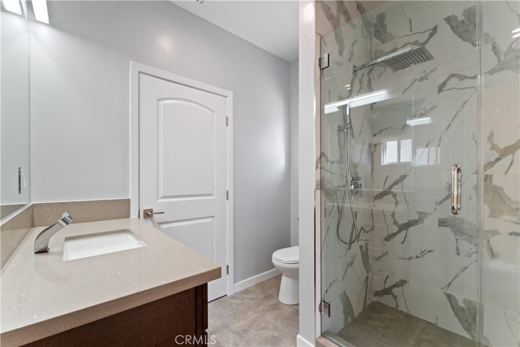 6942 Valmont Street Tujunga, CA 91042 - Photo 16 of 22 a bathroom with a sink a toilet and shower