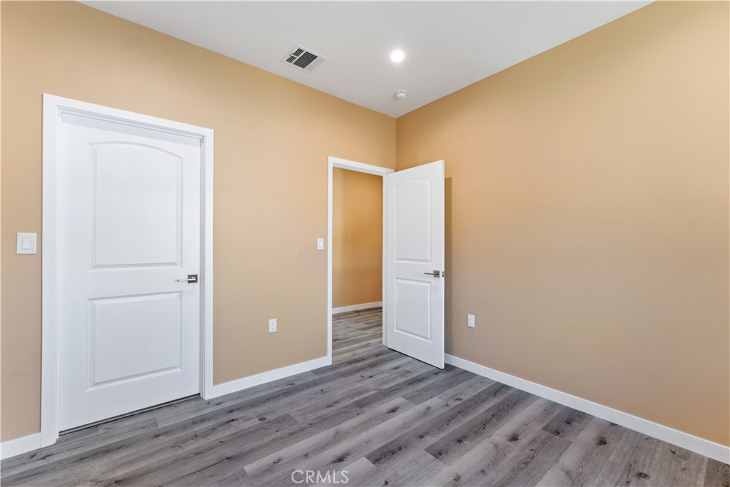 6942 Valmont Street Tujunga, CA 91042 - Photo 18 of 22 an empty room with wooden floor and closet