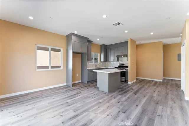 a view of kitchen with granite countertop cabinets and refrigerator